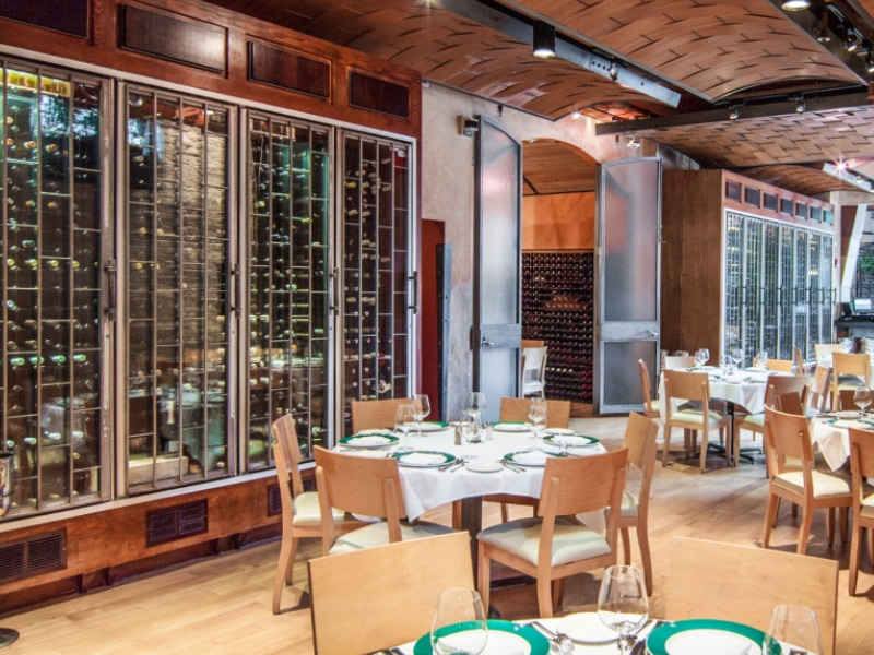 Floor to Ceiling Wine Racks Flanking Walls of Fine Dining Restaurant