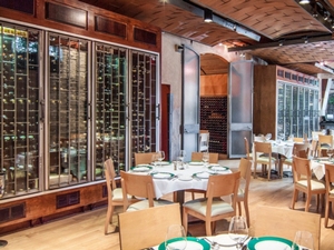 Floor to Ceiling Wine Racks Flanking Walls of Fine Dining Restaurant 